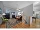Spacious living area featuring a fireplace, hardwood floors, and seamless transitions to other rooms, ideal for gatherings at 160 Fernbrook Dr, Mooresville, NC 28117