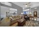 Bright open living room showcasing hardwood floors and seamless flow into modern kitchen at 160 Fernbrook Dr, Mooresville, NC 28117