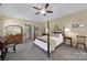 Spacious main bedroom with a four-poster bed, ceiling fan, and neutral decor at 160 Fernbrook Dr, Mooresville, NC 28117