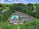 Aerial view of community pool, clubhouse, boat storage and parking surrounded by mature trees at 160 Fernbrook Dr, Mooresville, NC 28117