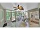 Bright sunroom with multiple windows, offering views of the private wooded backyard and comfortable seating at 160 Fernbrook Dr, Mooresville, NC 28117