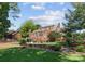 Spacious backyard with lush lawn and a charming brick home with a landscaped garden at 222 E Carter St, Lincolnton, NC 28092