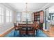 Elegant dining room with wood table, chairs, chandelier, and custom china cabinet on a blue rug at 222 E Carter St, Lincolnton, NC 28092