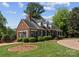 Beautiful brick home featuring manicured landscaping, a circular driveway, and a charming front porch at 222 E Carter St, Lincolnton, NC 28092