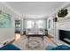 Bright living room features a neutral sofa, fireplace, and large windows with charming shutters at 222 E Carter St, Lincolnton, NC 28092