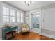 Sunroom nook with hardwood floors, shuttered windows, and access to a bathroom at 222 E Carter St, Lincolnton, NC 28092