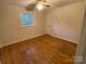 Cozy bedroom with hardwood floors, neutral walls, and a view to the outside at 224 Locust Ave, Locust, NC 28097