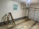 Clean garage space with a ladder, ready for parking or storage at 224 Locust Ave, Locust, NC 28097
