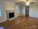 Bright living room with a beautiful fireplace and hardwood floors throughout at 224 Locust Ave, Locust, NC 28097