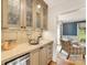 Cozy bar area features a sink, storage cabinets, and beverage cooler at 2611 Forest Dr, Charlotte, NC 28211