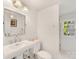 Bright bathroom with stylish mirror, pedestal sink, white walls and tile flooring at 2611 Forest Dr, Charlotte, NC 28211