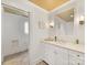 Stylish bathroom with marble countertop, white cabinetry, with tile flooring at 2611 Forest Dr, Charlotte, NC 28211