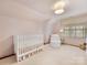 Cozy bedroom featuring a white crib, white walls and chair at 2611 Forest Dr, Charlotte, NC 28211