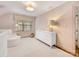 Cozy bedroom featuring a white dresser, chair, neutral walls, and hardwood floors at 2611 Forest Dr, Charlotte, NC 28211