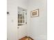 Charming hallway featuring a dutch door, shiplap walls and decorative framed art at 2611 Forest Dr, Charlotte, NC 28211