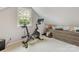 Bright exercise room featuring a Peloton bike, natural light, and built-in storage for organized fitness at 2611 Forest Dr, Charlotte, NC 28211