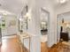 Bright foyer with hardwood floors, elegant console table, and views into the dining room at 2611 Forest Dr, Charlotte, NC 28211