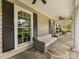 Covered front porch showcases a cozy seating area with neutral sofa and a ceiling fan at 2611 Forest Dr, Charlotte, NC 28211