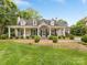 Charming single-story home featuring a welcoming front porch, manicured lawn, and mature landscaping at 2611 Forest Dr, Charlotte, NC 28211