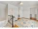 Inviting hallway features beautiful rug, hardwood floors, chair and an abundance of natural light at 2611 Forest Dr, Charlotte, NC 28211