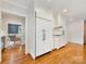 Bright kitchen features white cabinets, stainless steel appliances, and hardwood floors at 2611 Forest Dr, Charlotte, NC 28211