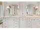 Bright main bathroom featuring double vanity, large mirrors, and white cabinets at 2611 Forest Dr, Charlotte, NC 28211