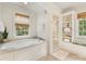 Elegant bathroom featuring a soaking tub, glass shower, and built in shelves at 2611 Forest Dr, Charlotte, NC 28211