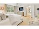 Bright bedroom featuring a large window, TV, and ensuite bathroom with built in vanity at 2611 Forest Dr, Charlotte, NC 28211