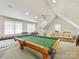 Large recreational room featuring a pool table, neutral colors, and a casual seating area for relaxation at 2611 Forest Dr, Charlotte, NC 28211
