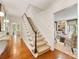 Hallway features a staircase with carpeted steps, hardwood floors, and an inviting living area at 2611 Forest Dr, Charlotte, NC 28211