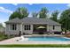 Backyard boasts a covered patio and a pool with built in chairs for ultimate relaxation and enjoyment at 2646 Lee Lawing Rd, Lincolnton, NC 28092