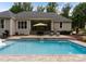 Resort-style backyard with a sparkling pool, covered patio and seating area, perfect for entertaining at 2646 Lee Lawing Rd, Lincolnton, NC 28092