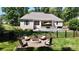 Spacious backyard with a fire pit, pool, patio, and lush greenery at 2646 Lee Lawing Rd, Lincolnton, NC 28092