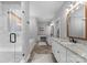 Bright bathroom featuring double sinks, vanities, a shower, a soaking tub and herringbone wood floors at 2646 Lee Lawing Rd, Lincolnton, NC 28092