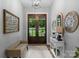 Inviting foyer with a decorative console table, mirror and front door with sidelights at 2646 Lee Lawing Rd, Lincolnton, NC 28092
