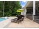 Patio with lounge chairs and umbrella next to a swimming pool at 2646 Lee Lawing Rd, Lincolnton, NC 28092