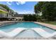 Inviting pool with in-water loungers, stone accents, and lush landscaping at 2646 Lee Lawing Rd, Lincolnton, NC 28092