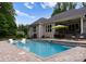 Beautiful pool with waterfall feature and comfortable seating area, perfect for relaxation at 2646 Lee Lawing Rd, Lincolnton, NC 28092