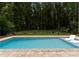 Backyard oasis with in-ground pool and ample space for lounging and enjoying the sun in privacy at 2646 Lee Lawing Rd, Lincolnton, NC 28092