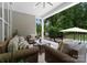 Covered porch features a seating area with plush cushions and a scenic backyard view at 2646 Lee Lawing Rd, Lincolnton, NC 28092