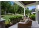 Cozy porch with comfortable seating overlooking the manicured lawn and lush greenery at 2646 Lee Lawing Rd, Lincolnton, NC 28092