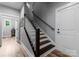 Stairway features wood steps with a white banister, side door and gray walls at 2646 Lee Lawing Rd, Lincolnton, NC 28092