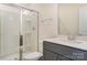 This bathroom features a glass-enclosed shower, a vanity with grey cabinets, and white countertops at 2907 W Trade St, Charlotte, NC 28208