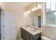 Bright bathroom featuring a double sink vanity, ample lighting, and a large mirror reflecting natural light at 2907 W Trade St, Charlotte, NC 28208