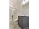 This bathroom features a glass-enclosed shower, a vanity with grey cabinets, and white countertops at 2907 W Trade St, Charlotte, NC 28208