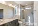 Bathroom featuring double sink vanity and glass-enclosed shower with seating at 2907 W Trade St, Charlotte, NC 28208