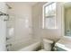 This bathroom features a tub, a shower, and a vanity with white countertops and silver hardware at 2907 W Trade St, Charlotte, NC 28208