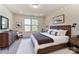Well-lit bedroom with neutral decor, wood furniture, and large windows at 2907 W Trade St, Charlotte, NC 28208
