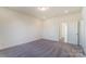 Empty bedroom with neutral carpet, ample light and view to ensuite bathroom at 2907 W Trade St, Charlotte, NC 28208