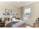 This bedroom features a wood frame bed, neutral walls, and picture window for ample natural light at 2907 W Trade St, Charlotte, NC 28208